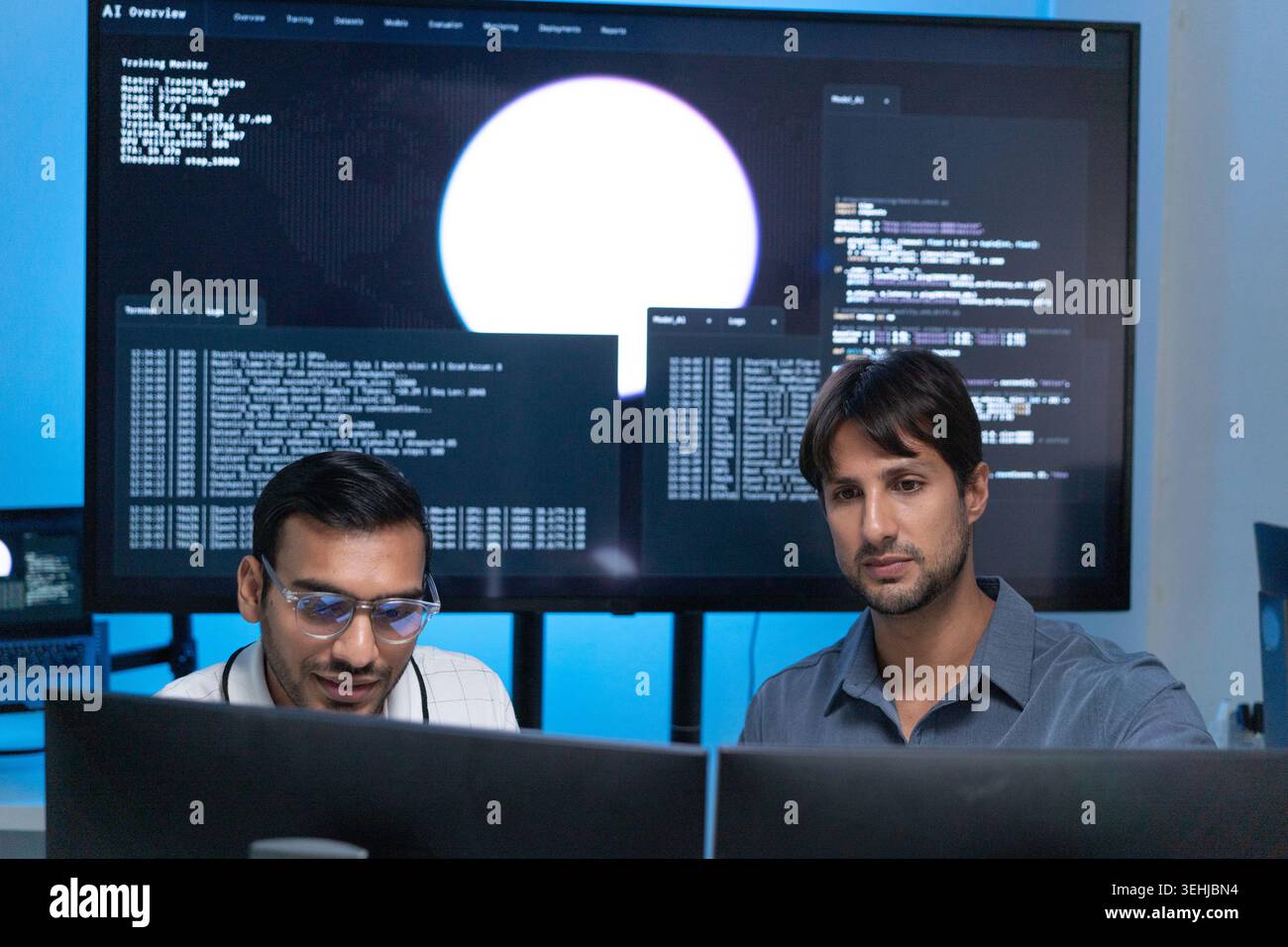 Software Developers Working With AI Code On Computers In Tech Office Stock Photo