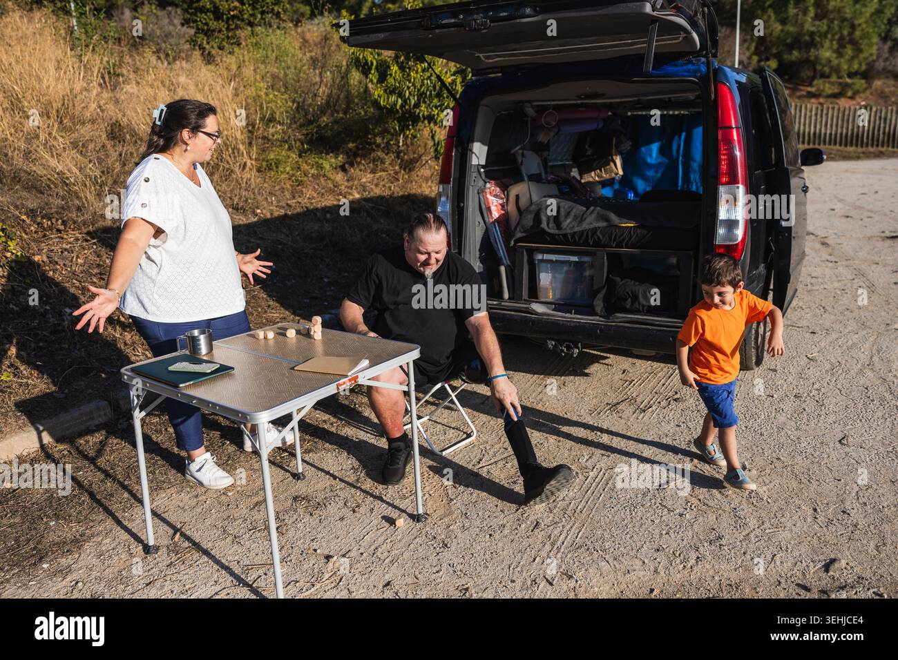 Family man with prosthetic leg playing outdoors Stock Photo