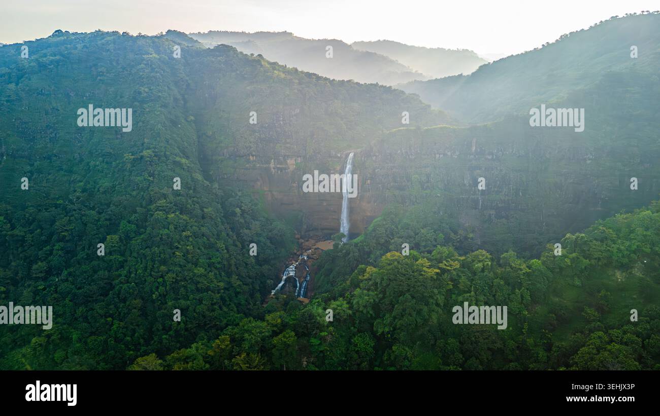 Aerial view of Cikanteh Waterfall cascading down a rocky cliff into a ...