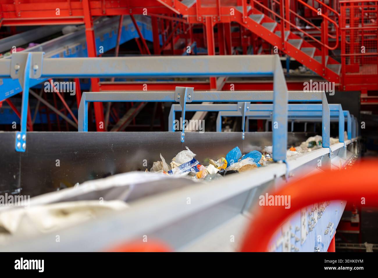 Conveyor belt transporting mixed waste materials inside a recycling ...