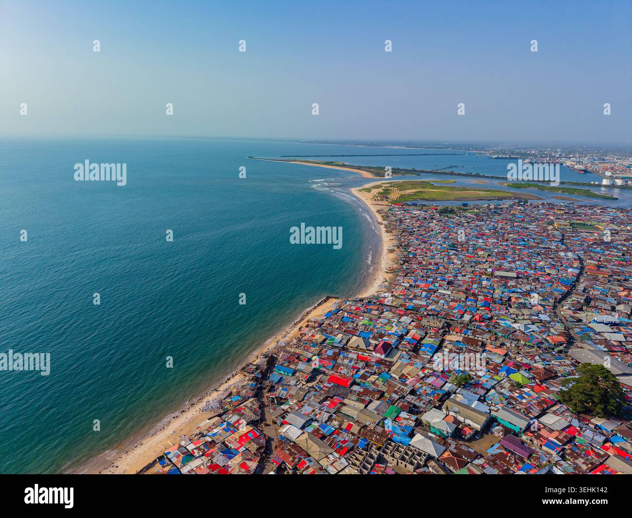 Aerial view of densely packed colorful rooftops of a coastal settlement ...