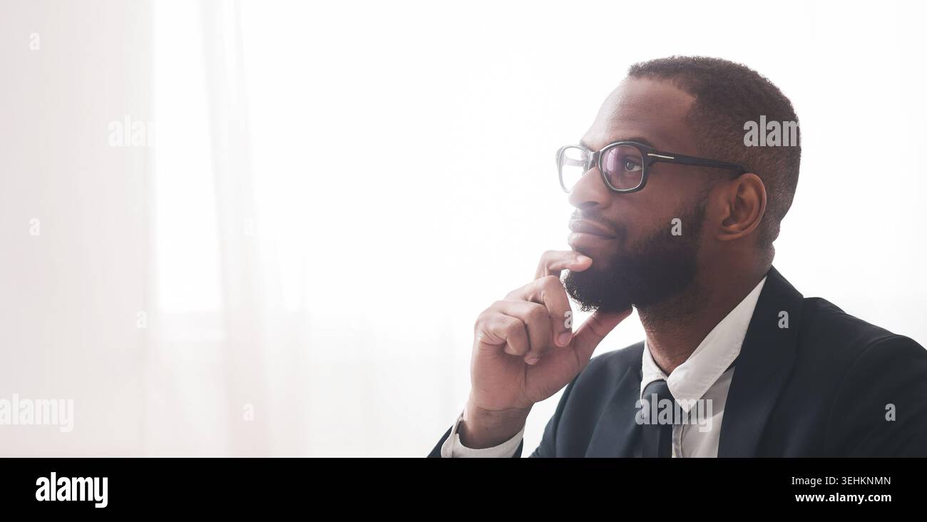 Close up of pensive black man in suit Stock Photo