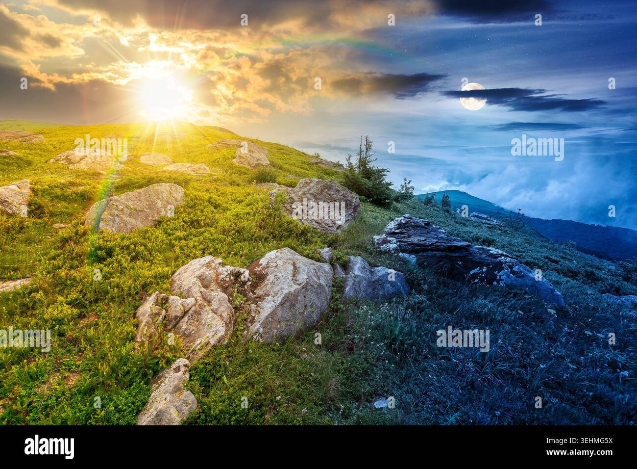 green landscape of mountain on summer solstice. view of rock among grass on the hillside. sun and moon in harmony over travel background and epic sky. Stock Photo