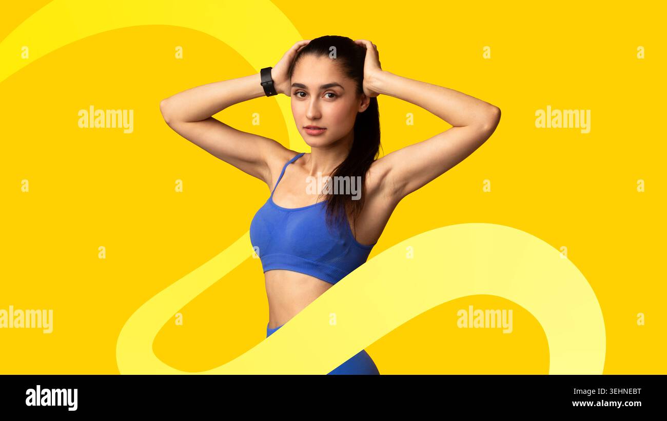 Young Woman Poses Confidently With Hands on Her Head in Bright Setting During Fitness Session Stock Photo