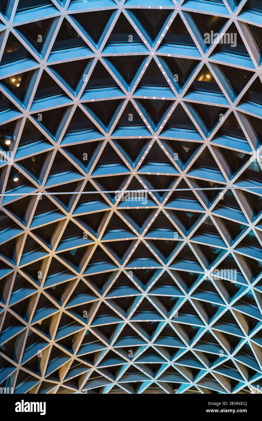 Futuristic symmetry architectural abstract modern blue building with triangular ceiling pattern and led lighting Stock Photo