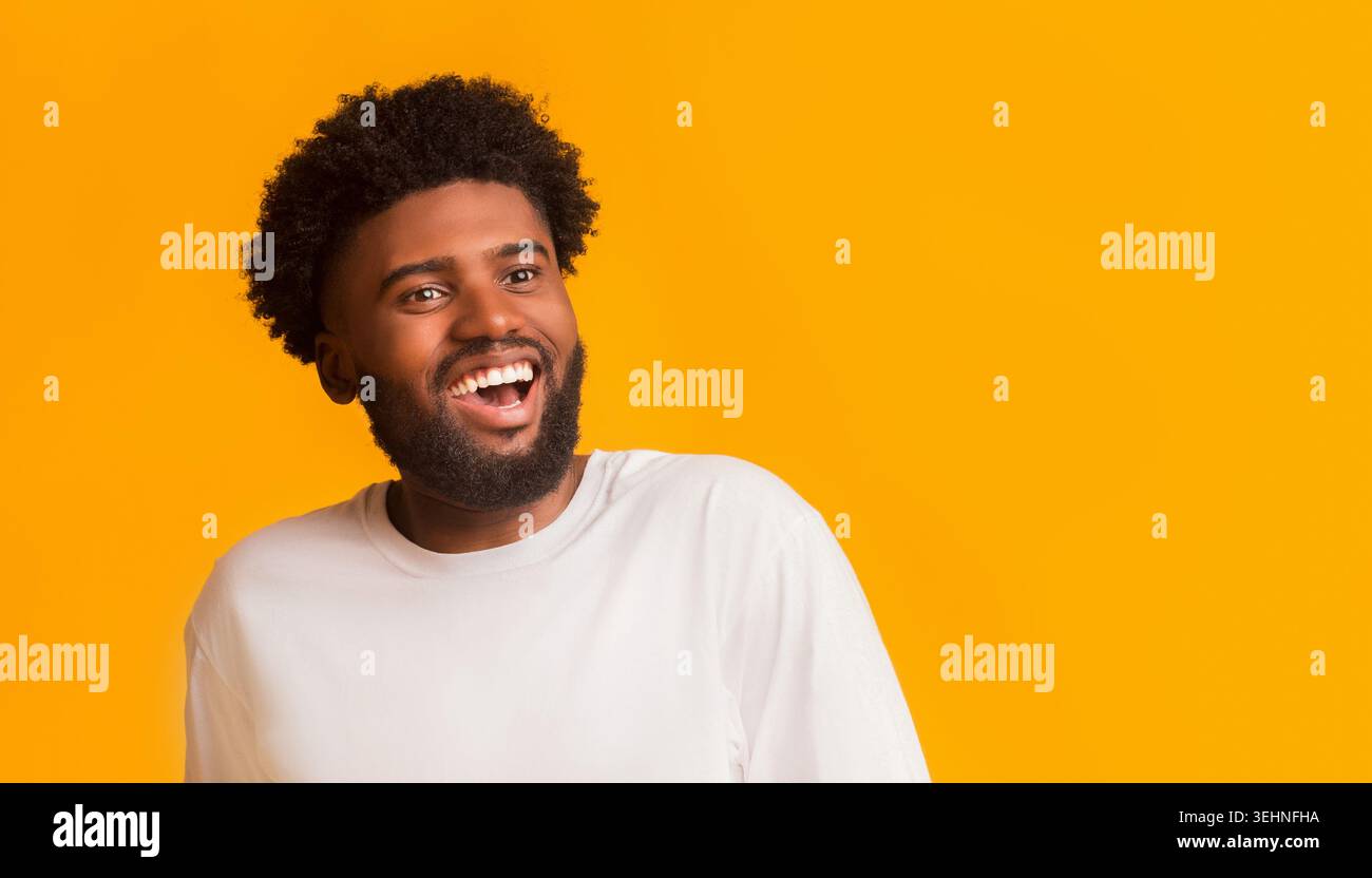 Excited happy black guy looking at empty space Stock Photo