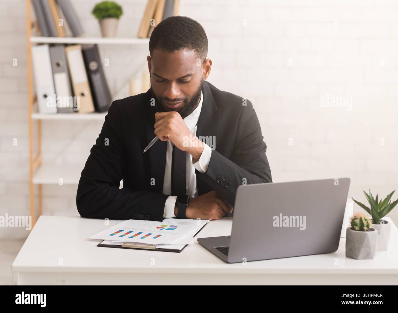 Serious businessman working on financial report in his office Stock Photo