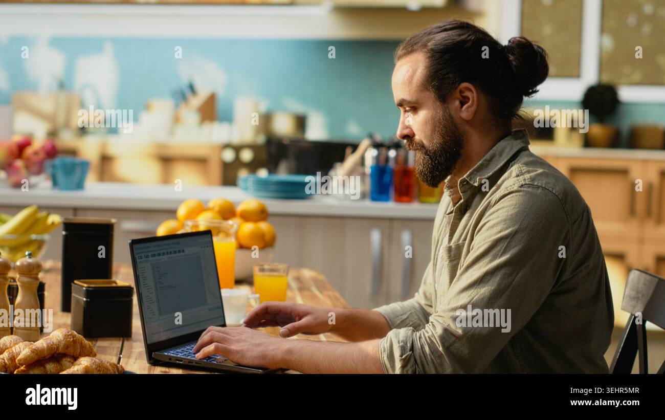 IT professional coding on laptop representing remote work for software development. Programmer writes source code and uses command-line tools, highlighting engineering and programming language. Stock Photo