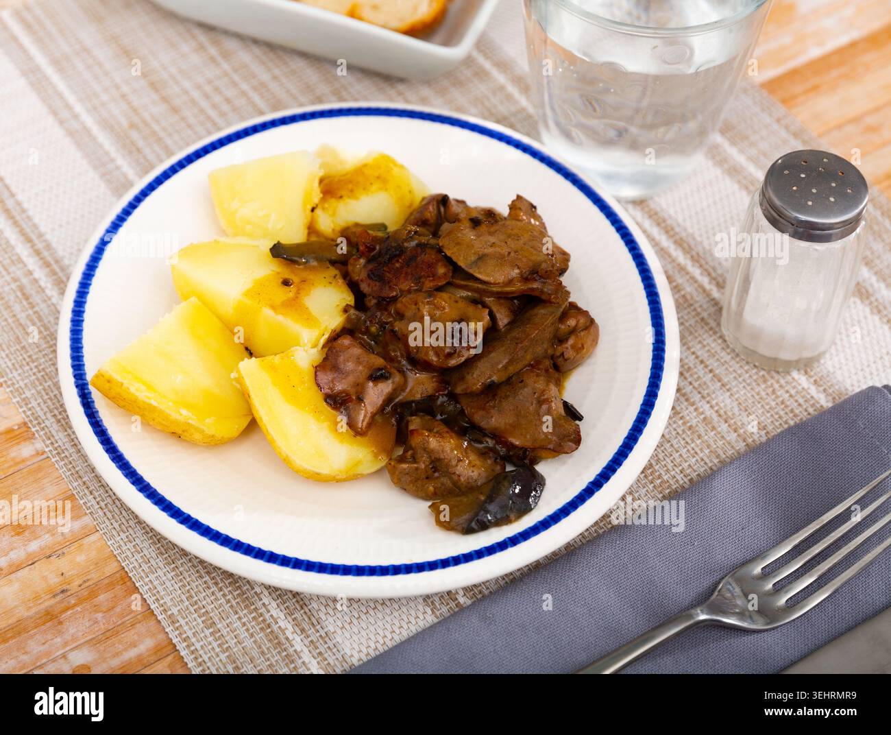 Fried rabbit liver served with boiled potato Stock Photo