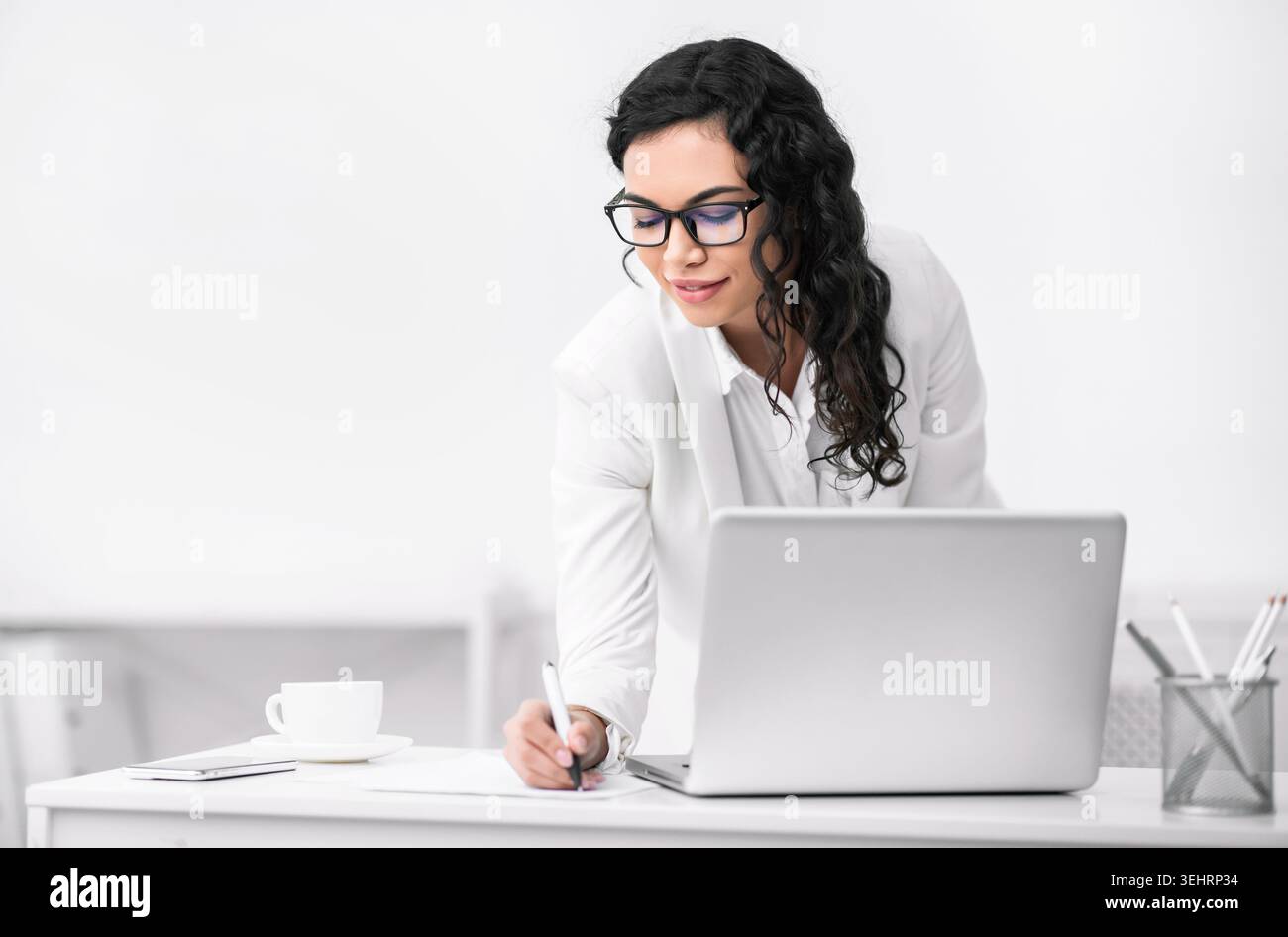 Mexican woman taking down some notes and ideas Stock Photo