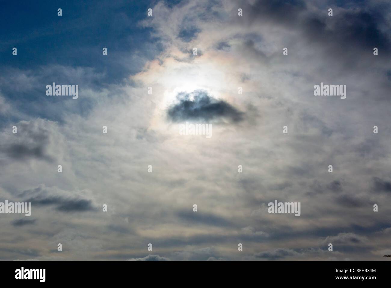 Sun is shining from behind the clouds Stock Photo