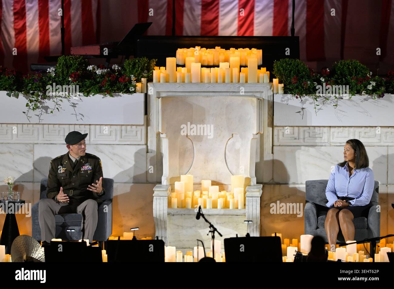 Lt. Col. Travis Taylor, left, speaks to Rebecca Eggers, the wife of ...
