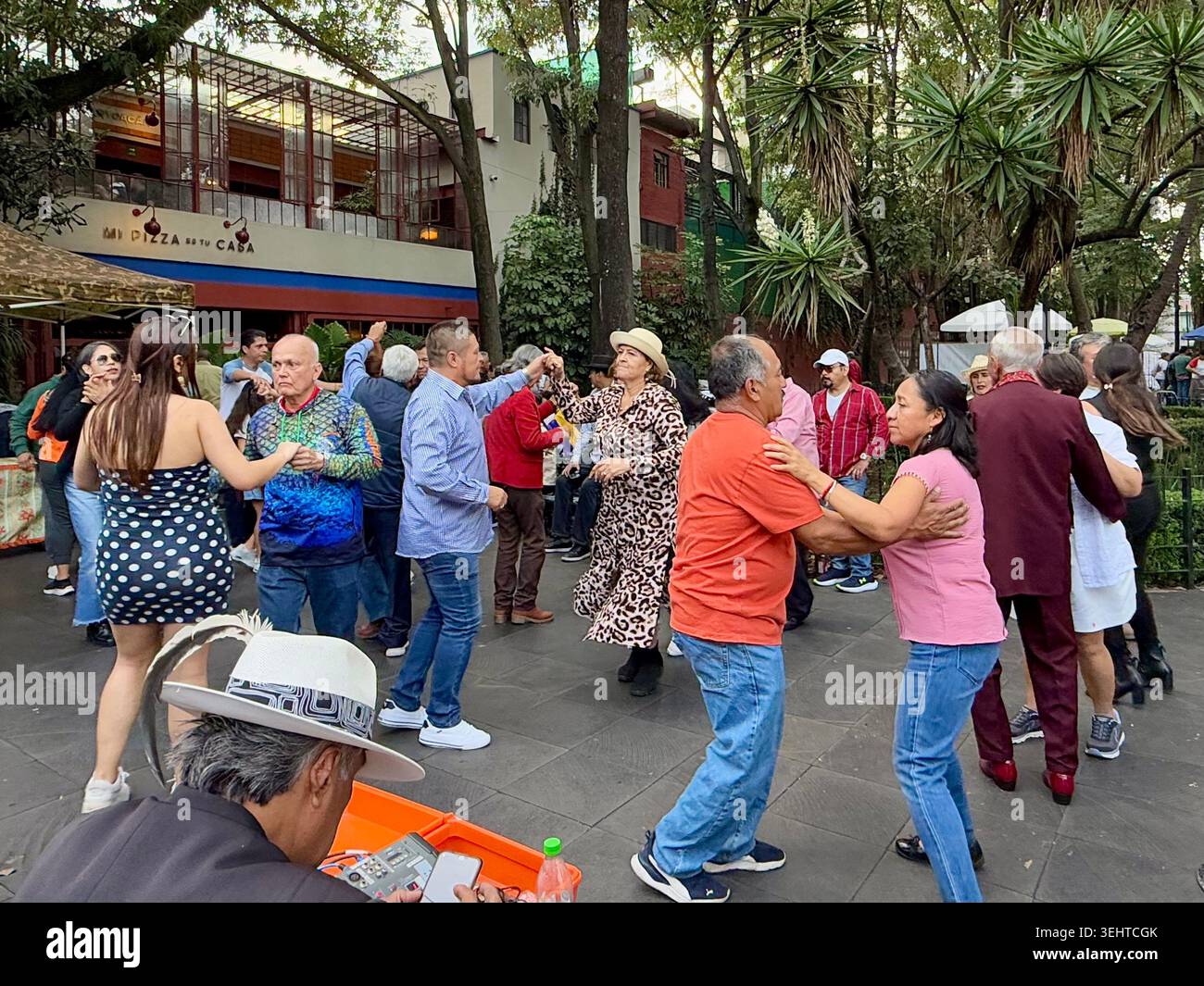 Couples dance in a public plaza in Coyoacán, Mexico City, reflecting the neighborhood’s lively social life and popular music culture - Smartphone Captured Stock Image