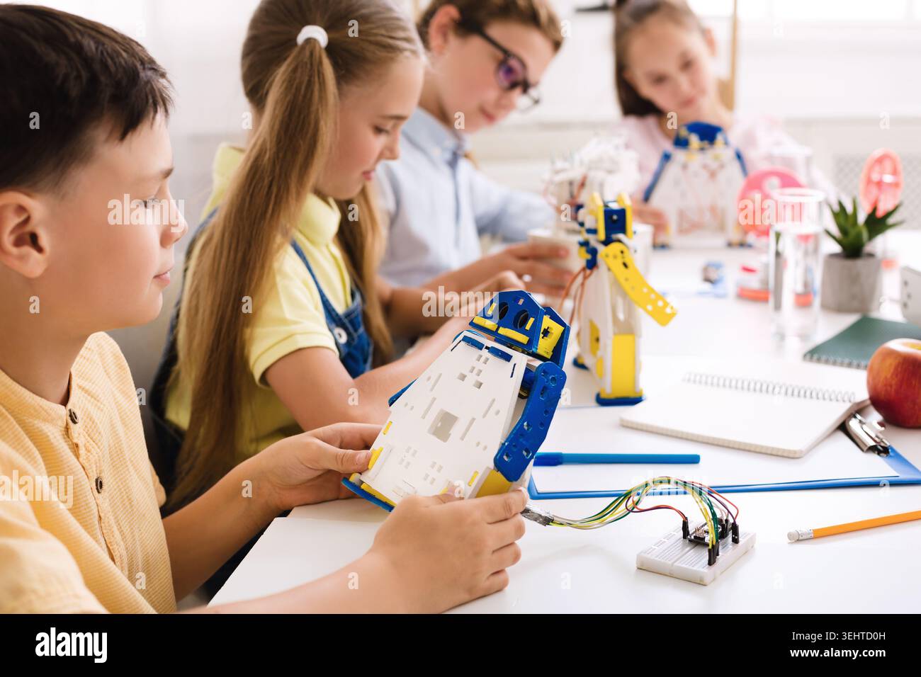 Students Engage in Robotics Workshop While Building Robot Models Stock Photo