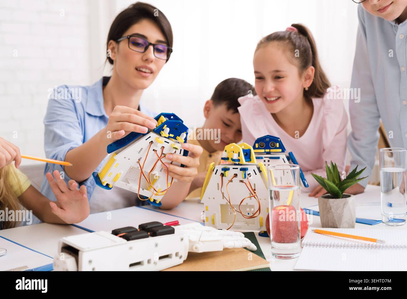 Children Engaging in a Robotics Workshop Guided by an Instructor Promoting Hands On Learning Stock Photo