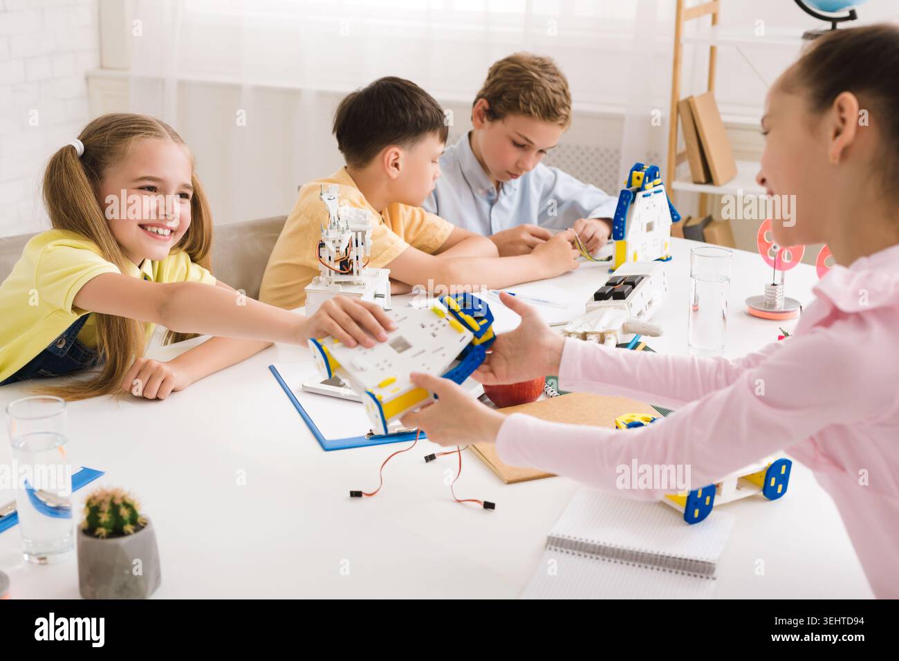 Children Engaged in Robotics Workshop While Learning and Collaborating on Projects Stock Photo