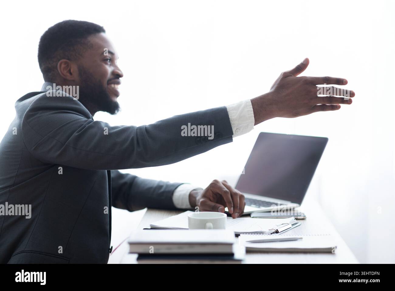 Friendly HR manager extending hand for handshake after successful interview Stock Photo