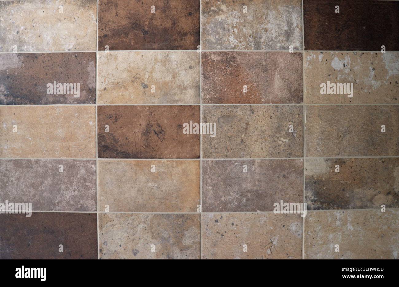 Old weathered  earthenware floor with multicolored large rectangle tiles. Background and texture. Stock Photo