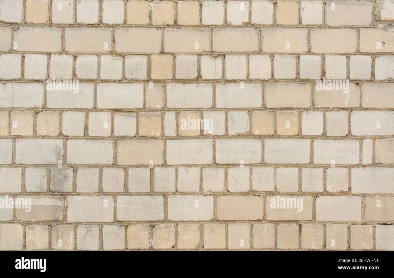 Old white brick wall texture background. Silicate brick blocks wall bg, ancient bricks fence, retro stonewall with copy space, grey brickwork exterior Stock Photo