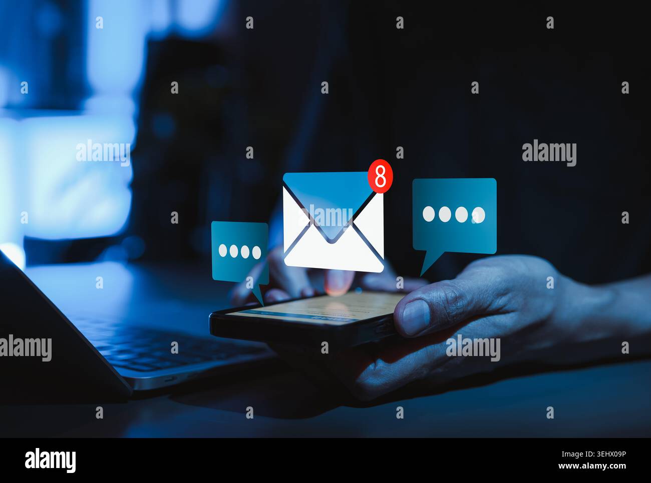 Email notification communication concept showing hand using smartphone with unread message alert, chat bubbles, and laptop for online messaging, Stock Photo