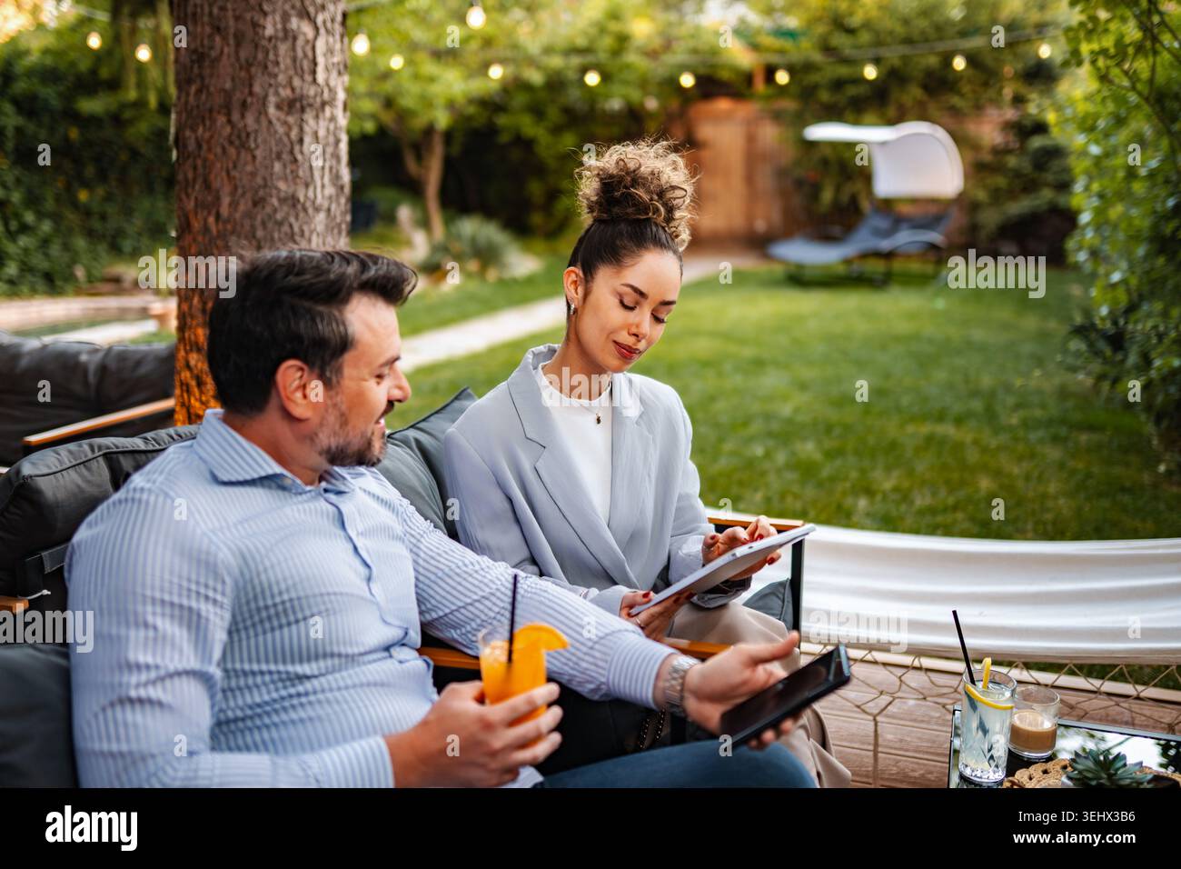 Business partners collaborating outdoors discussing project ideas Stock Photo