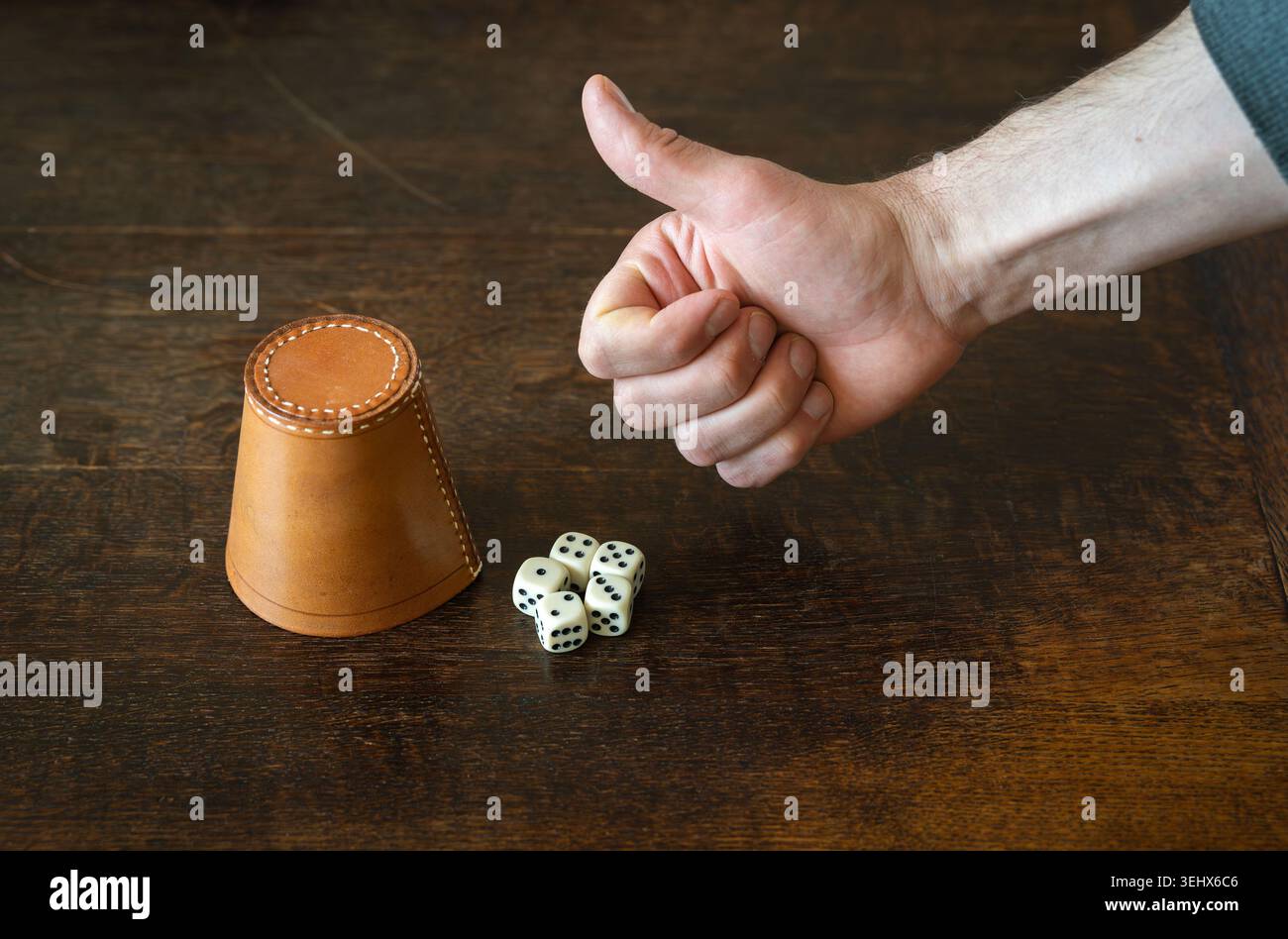 Thumbs up for winning straight in dice game, gamblers luck concept Stock Photo