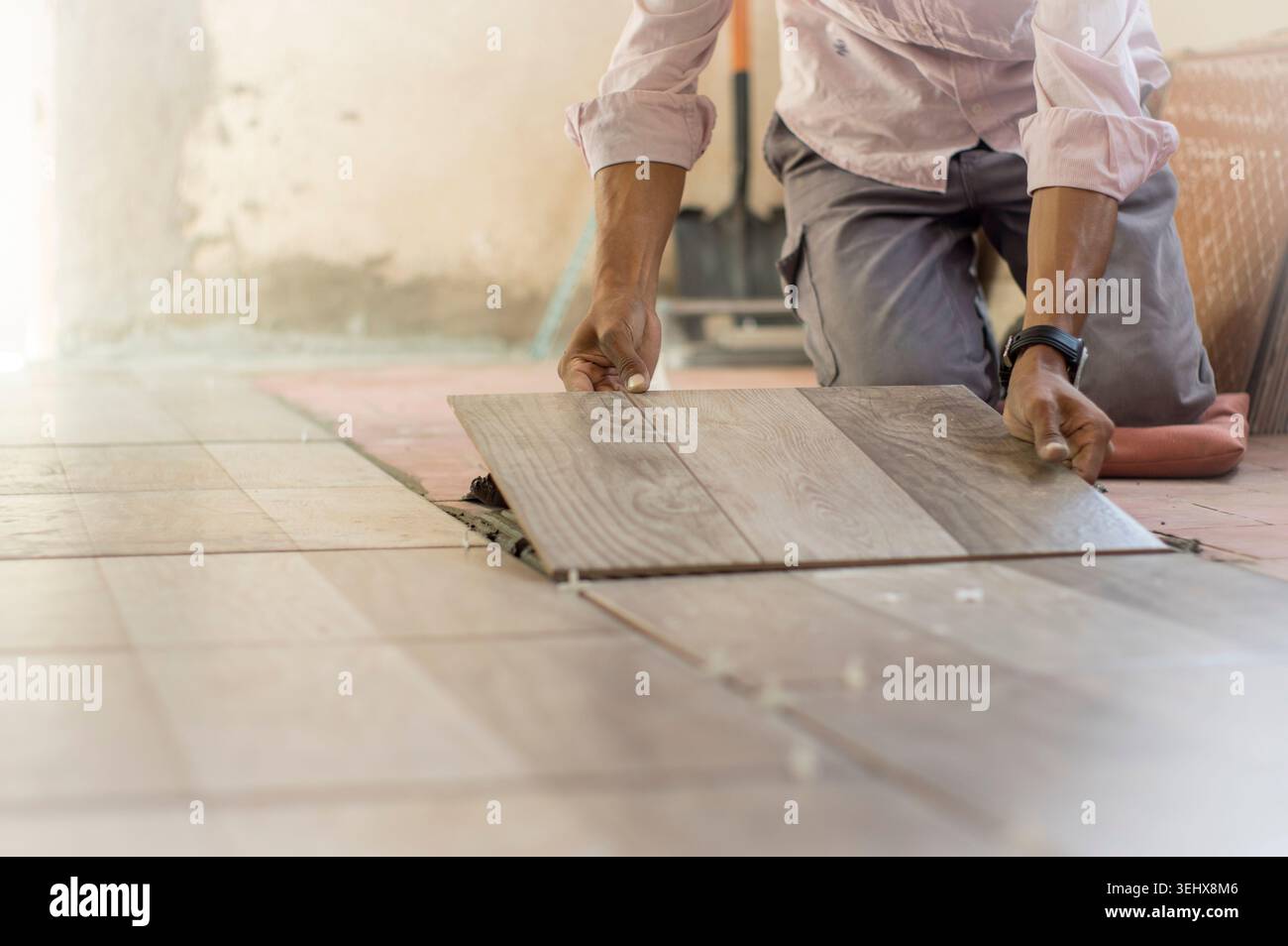 Worker installing a ceramic floor Stock Photo