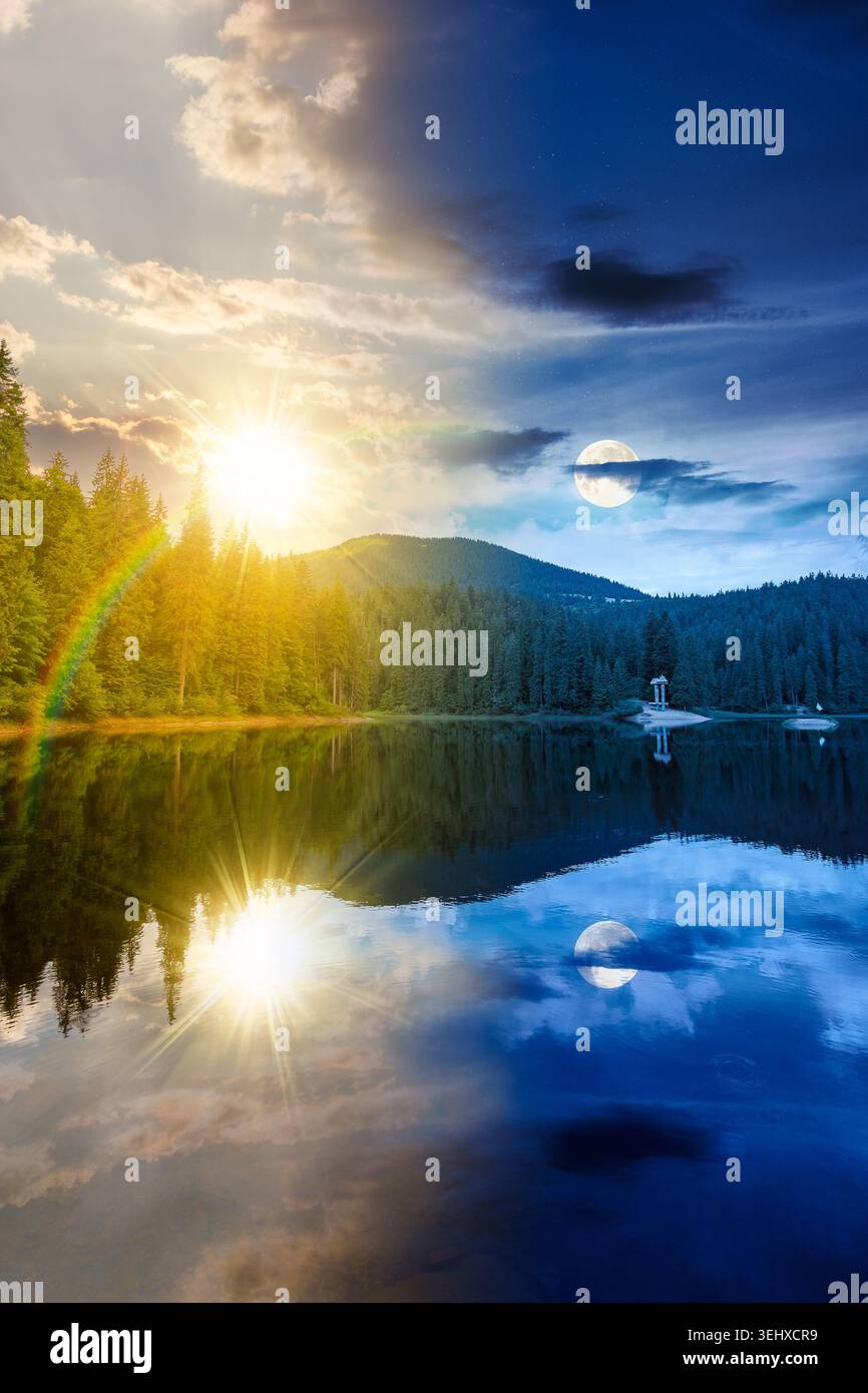 day meet night. landscape by the lake. coniferous forest near the lake and the forest mountain. epic summer solstice view of carpathian mountain refle Stock Photo