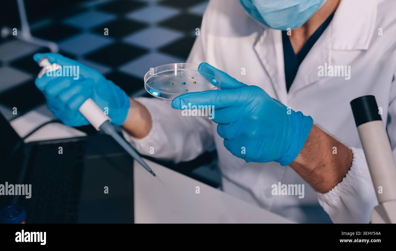 Lab technician experimenting in lab Stock Photo