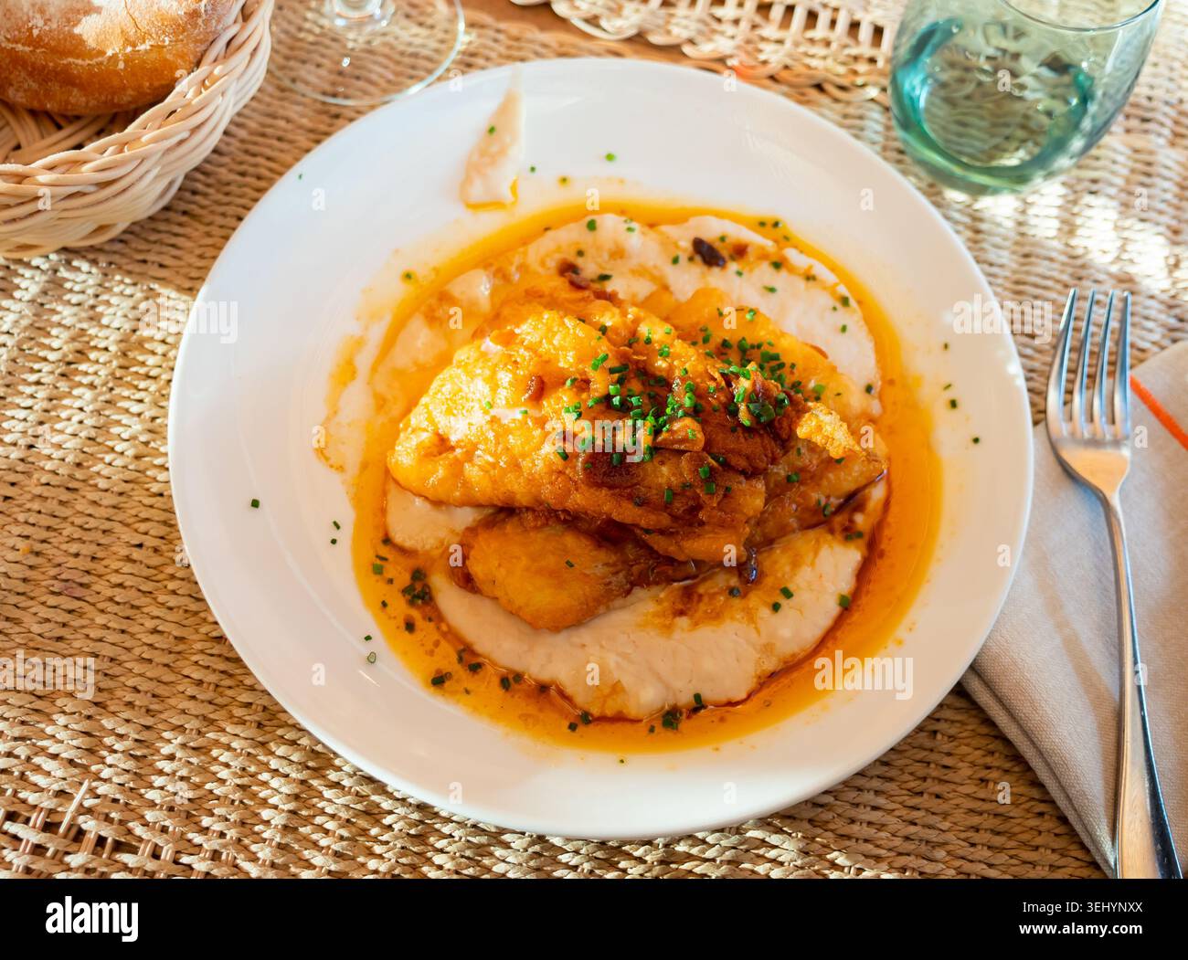 Fried cod with creamy white beans and gravy Stock Photo