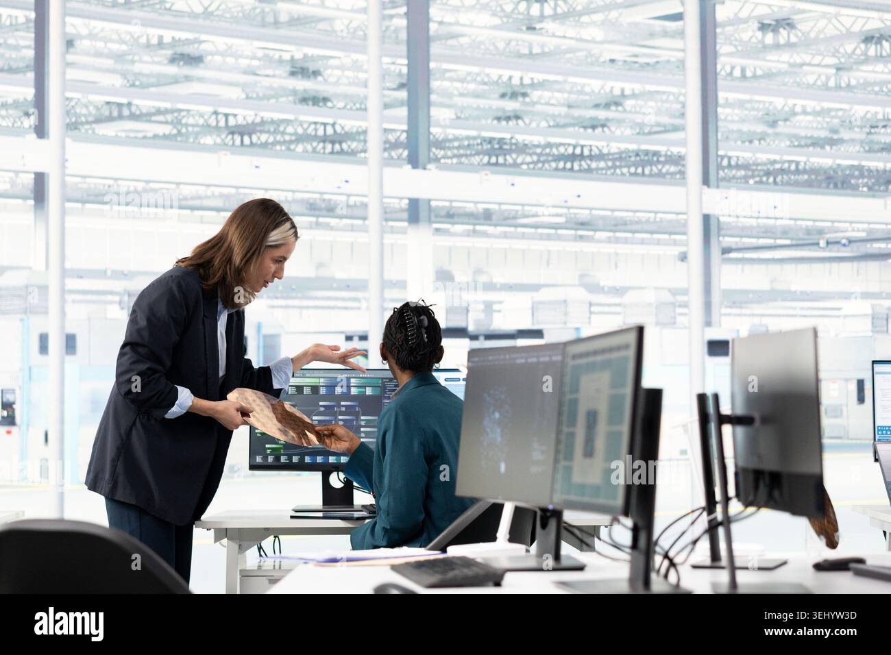 Hardware developer in microchip production fab office using machine learning to conduct RD study on SoC architecture design. Computer scientist develops cutting edge semiconductors technology using AI Stock Photo