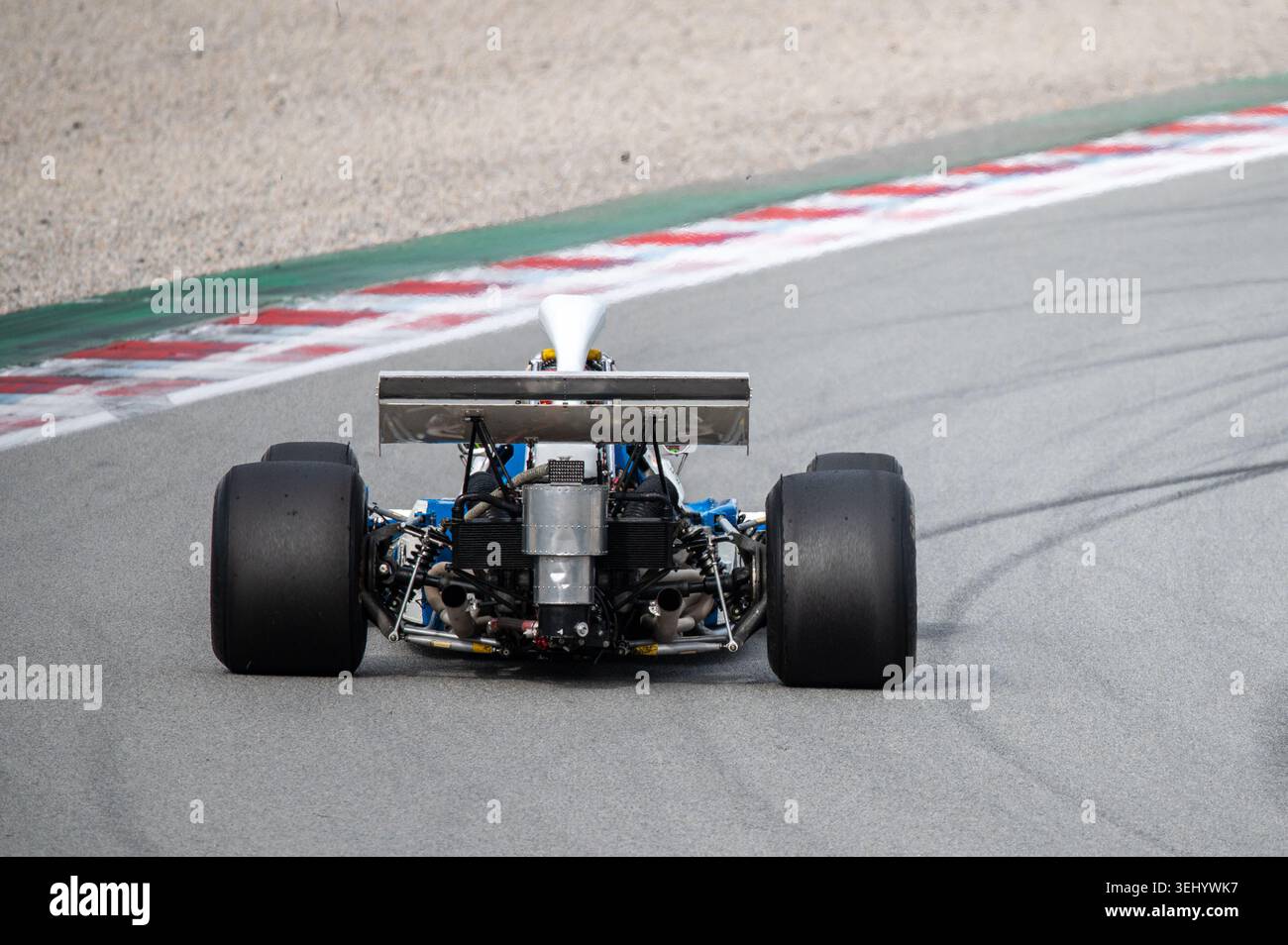Rear view of a vintage Matra MS120C Formula One racing car driving on a ...