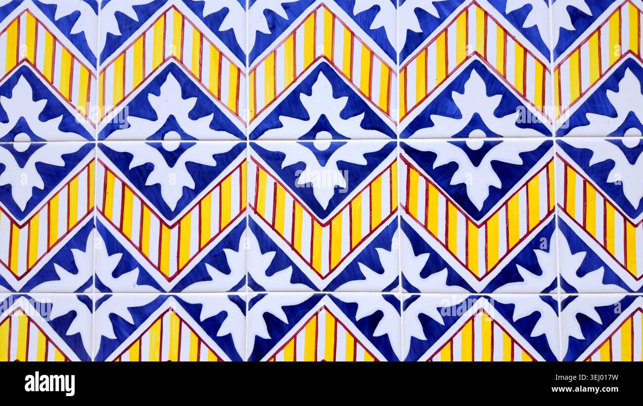 A close-up view of classic Portuguese glazed ceramic tiles, displaying a repeating diamond pattern. The glossy, smooth surface reflects light, emphasi Stock Photo