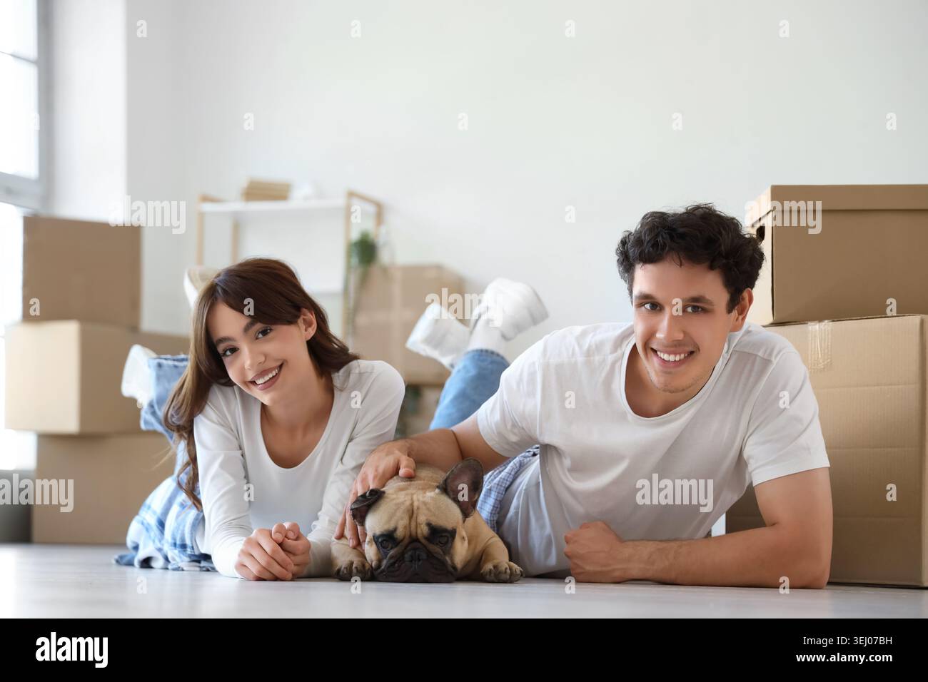 Fresh Look at Young Couple With French Bulldog Lying In Rented Apartment On