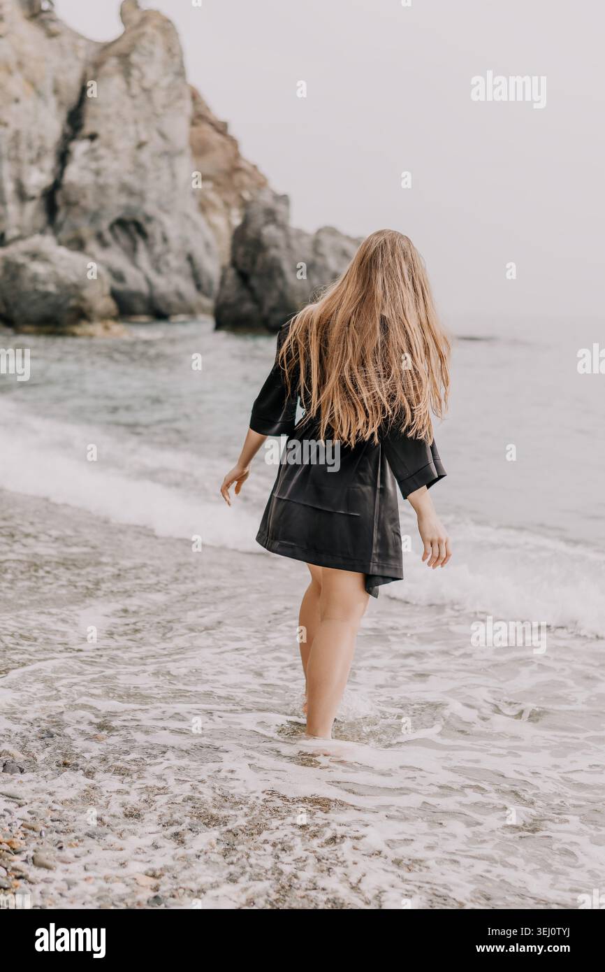 Woman walking on foamy shore hi-res stock photography and images - Alamy