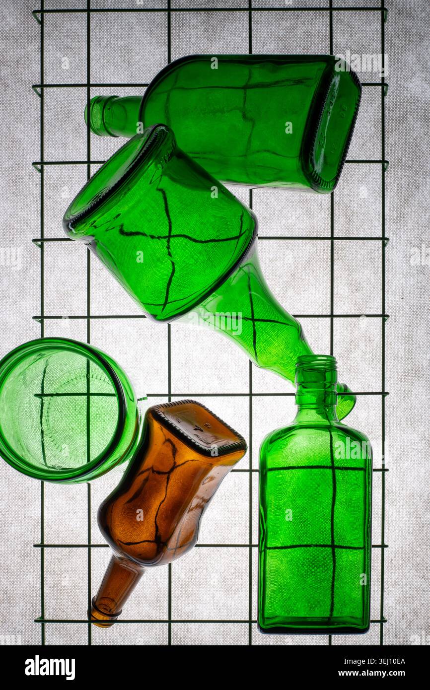 Three green empty bottles on a gray background Stock Photo