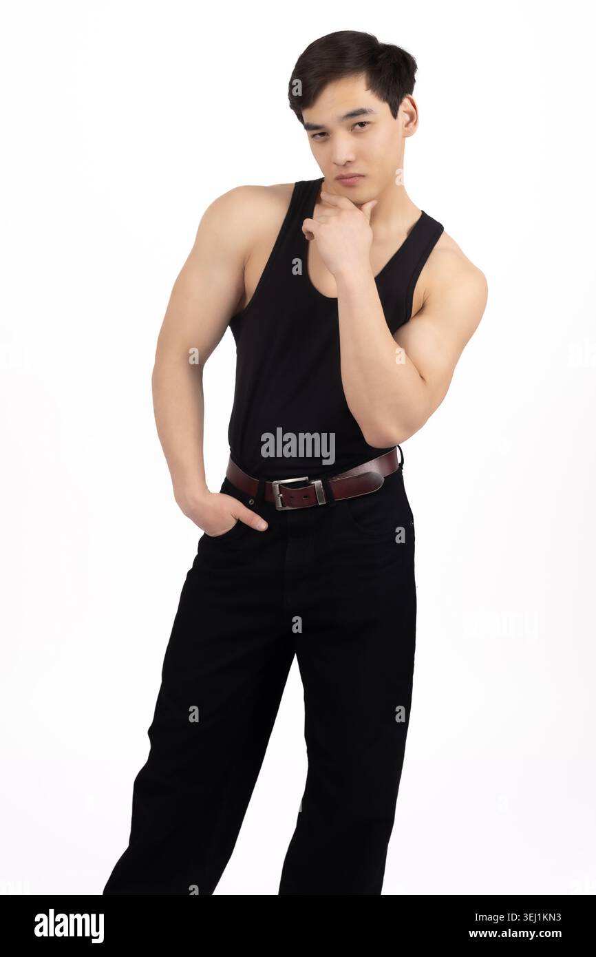 Young man posing with hand on his neck in studio Stock Photo