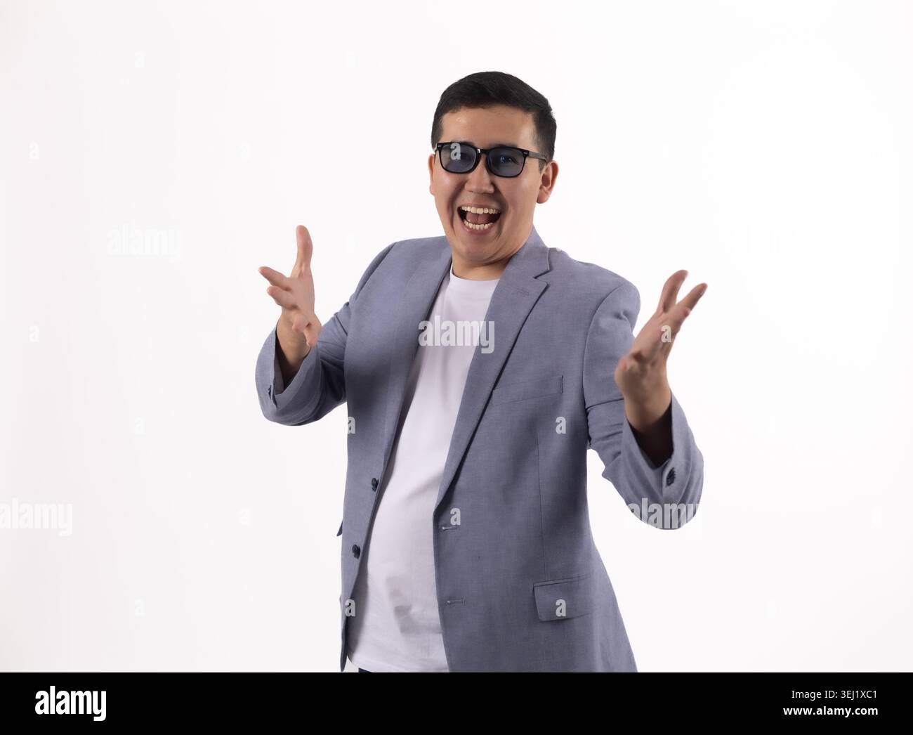 Young man gesturing with hands and smiling Stock Photo