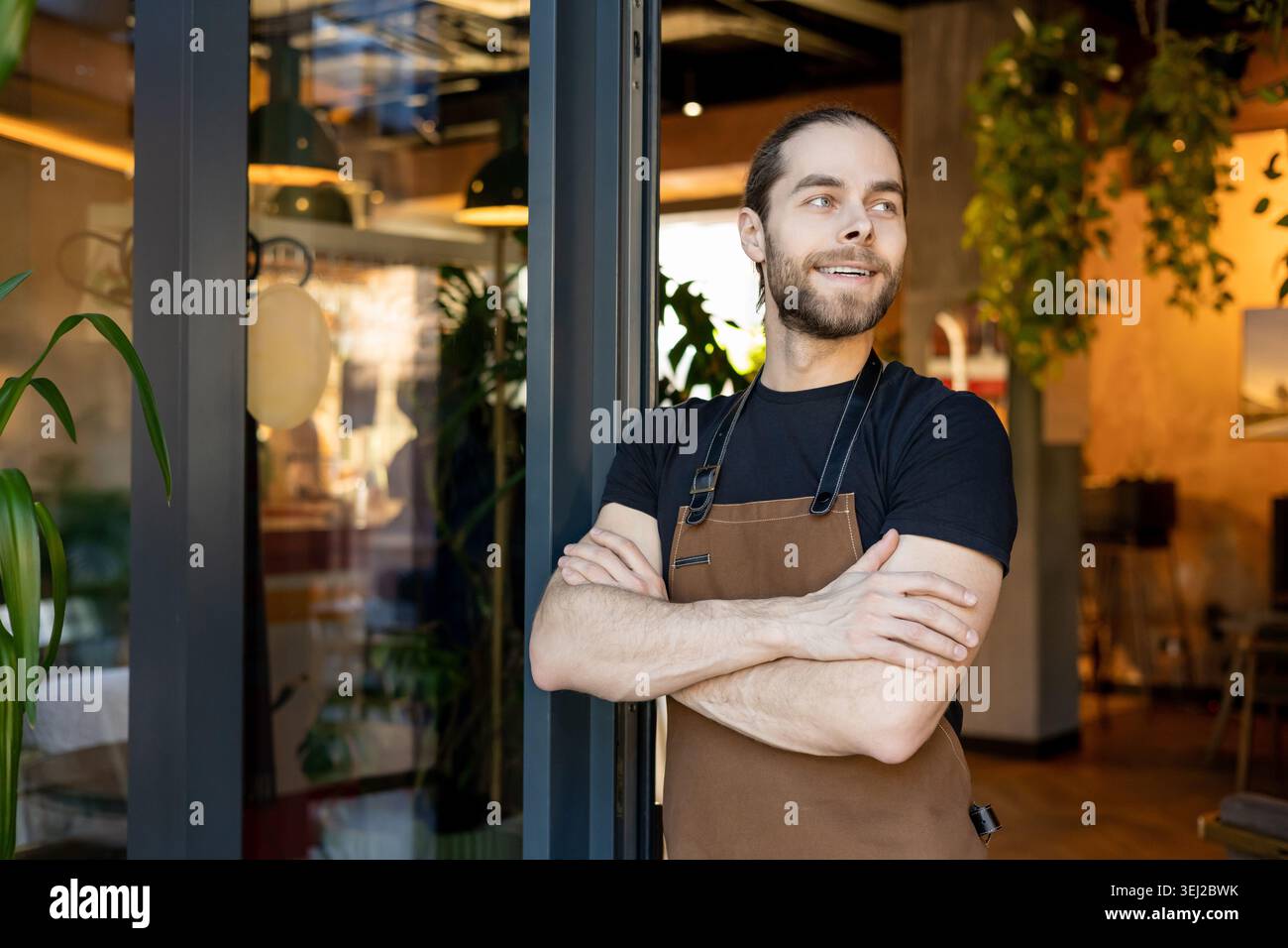 Successful entrepreneur looking away standing in cafe Stock Photo