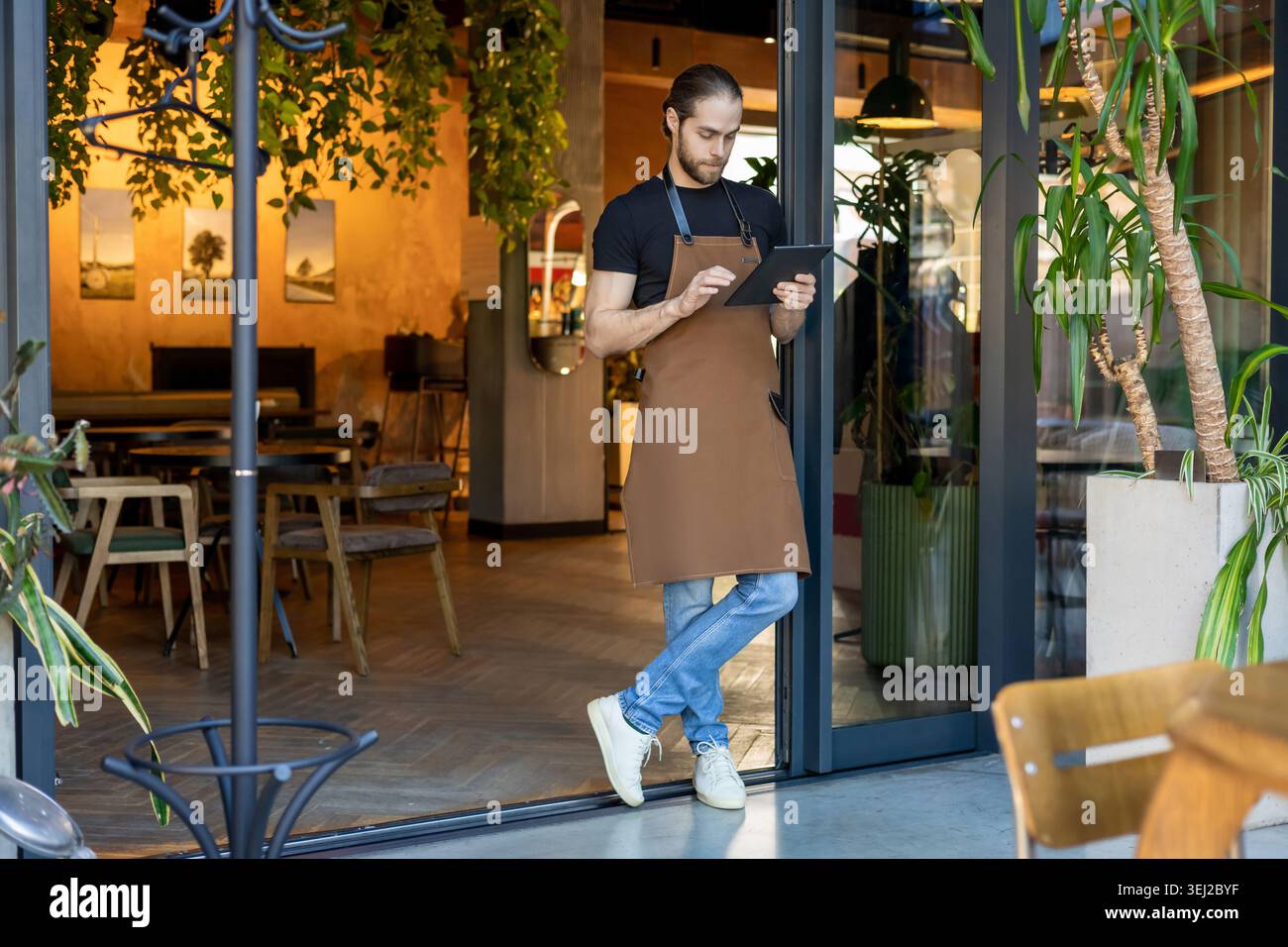 Small business owner checking data on tablet Stock Photo