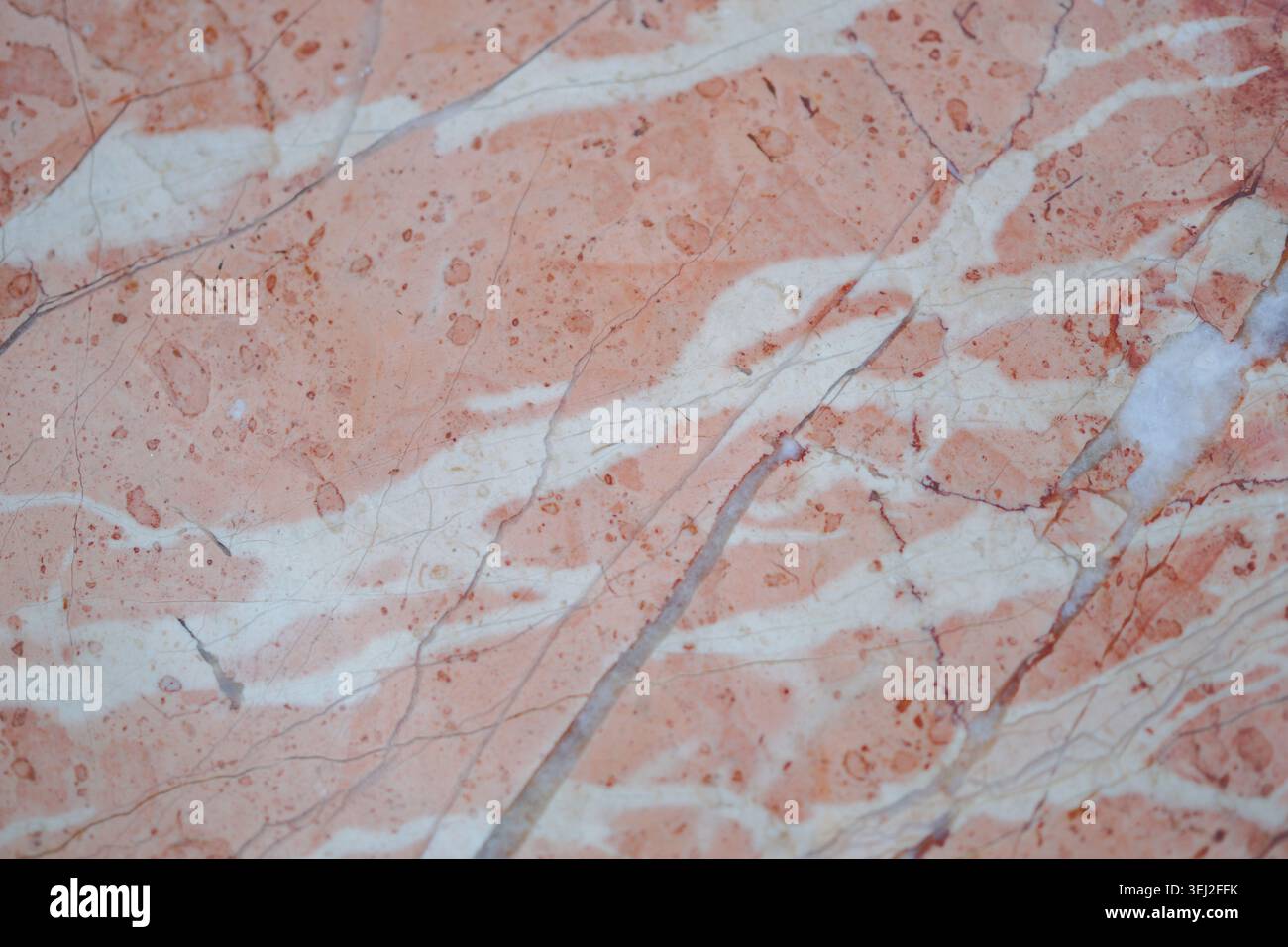 Marble surface with orange and white patterns seen up close Stock Photo