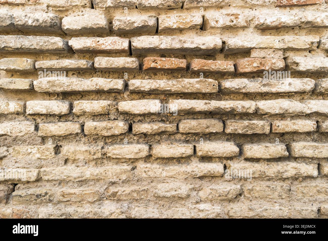 Weathered stained old brick wall background Stock Photo