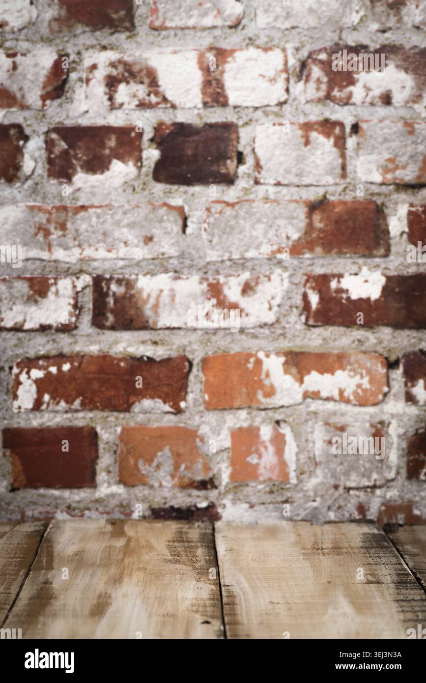 Wooden table top with Red brick wall background Stock Photo