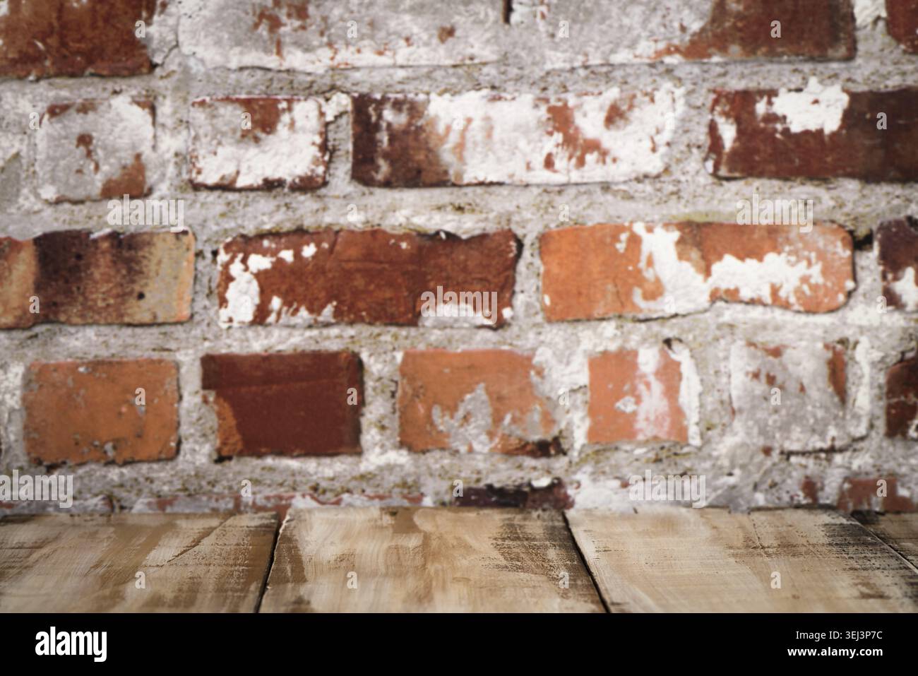 Wooden table top with Red brick wall background Stock Photo