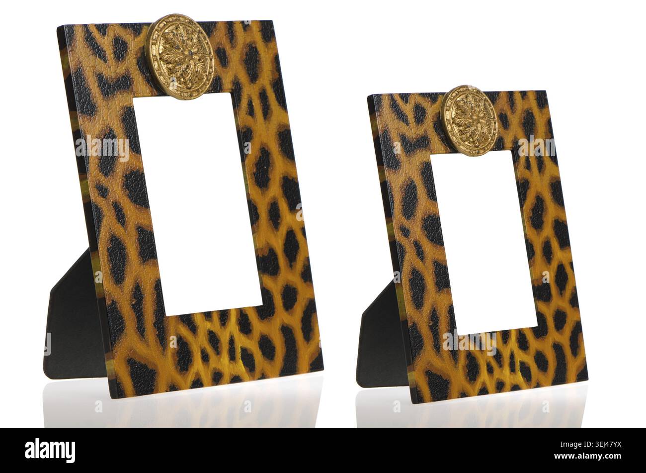 Two photo frames with leopard pattern decoration on white reflective background Stock Photo