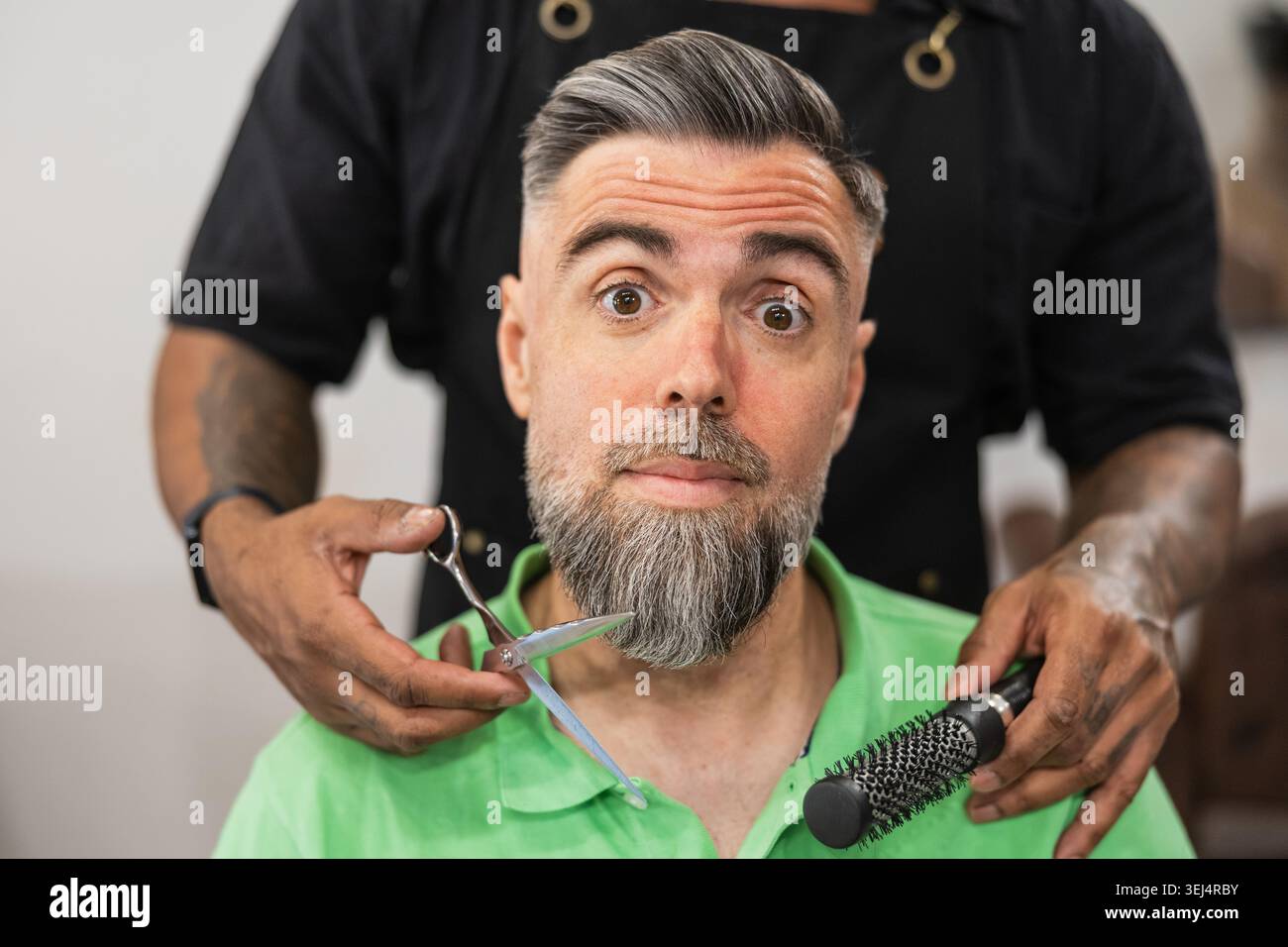Client reacting to barber services in salon Stock Photo