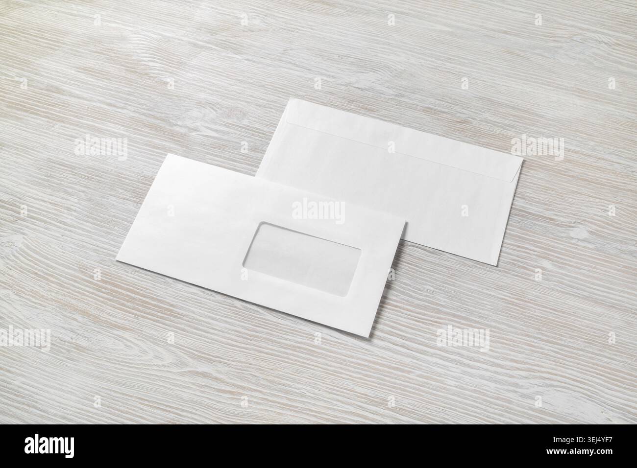 Photo of two blank paper envelopes on light wooden background. Back and front Stock Photo
