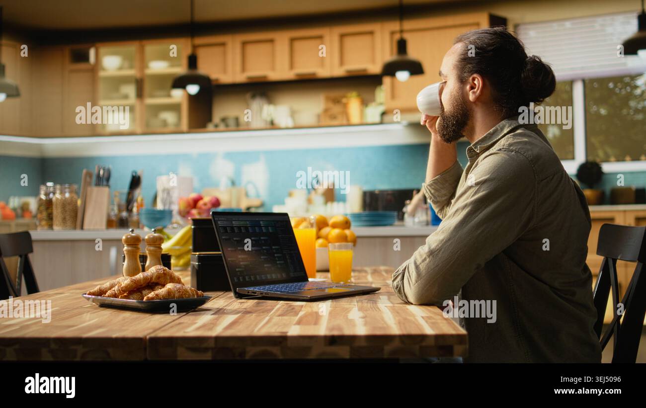 Man focused on programming and software development tasks. Laptop screen displays code, scripts and binary data, illustrating system maintenance and remote work in a high-tech occupation. Stock Photo