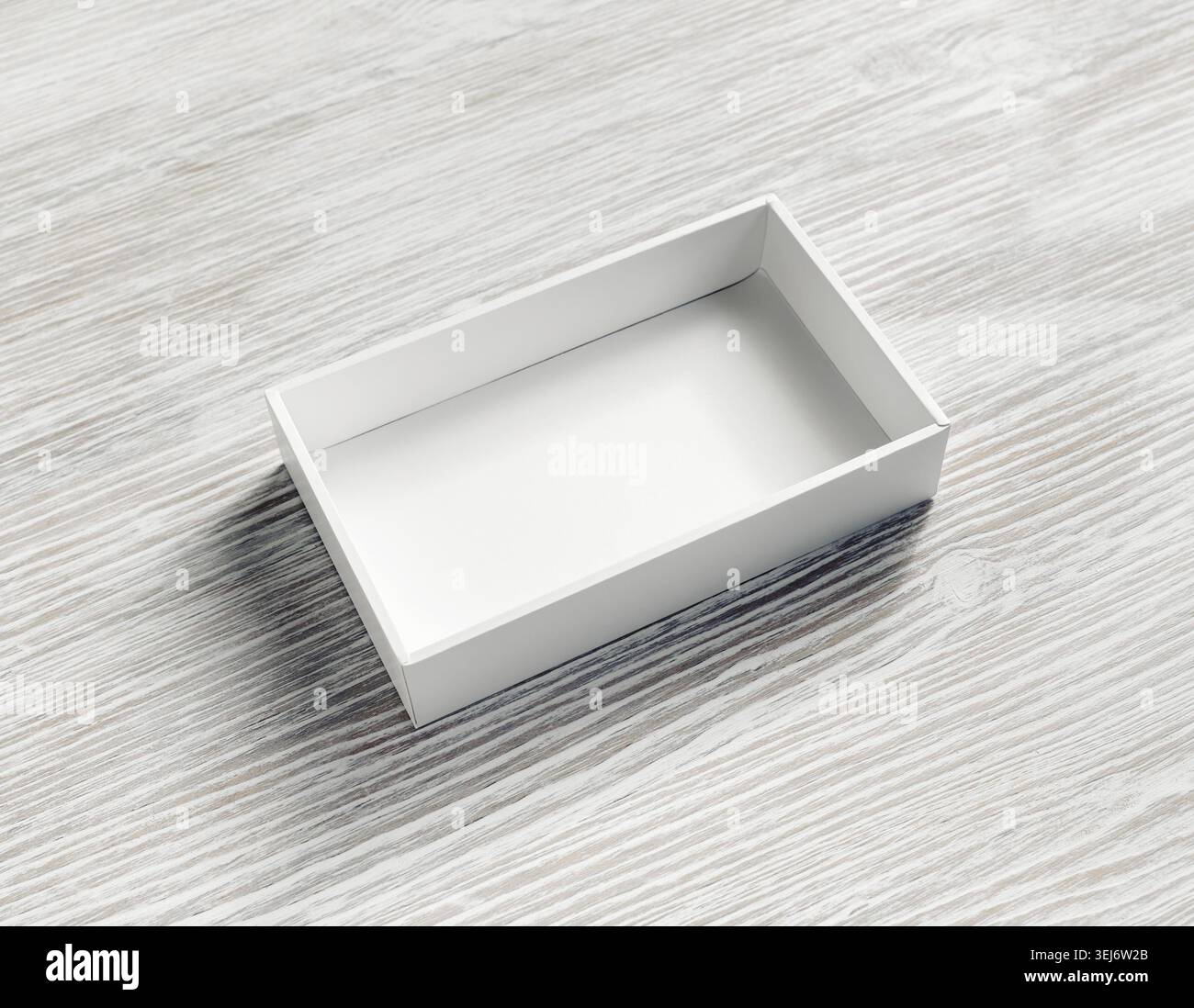 Blank white paper opened box on light wooden background Stock Photo