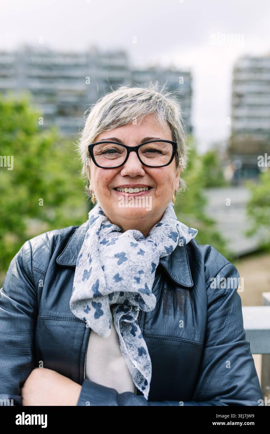 Smiling senior woman enjoying retired community life Stock Photo